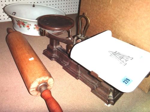 A cast iron and ceramic weighing scale, a glass lampshade and a rolling pin.