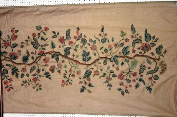 A large 19th century crewel work tapestry depicting leaves and flowers.