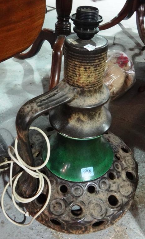 A large 20th century green and brown pottery lamp.