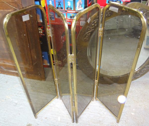A 20th century brass and smoked glass fire screen.