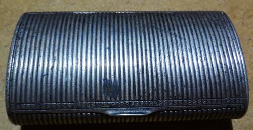 A European silver hinged lidded snuff box, of oval cylindrical form with reeded decoration.