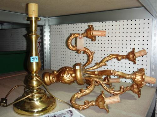 A gilt wood five branch chandelier and a brass table lamp.