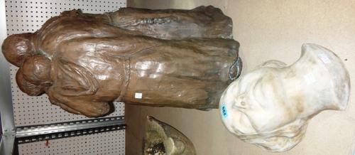 A bronzed resin figure group of three monks and a plaster mask of a female.