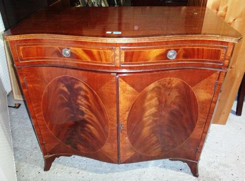 A reproduction mahogany side cabinet and a dining chair.