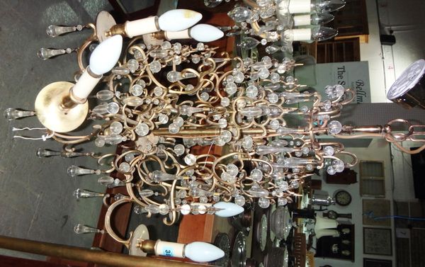 A French brass six light chandelier hung with glass drops.