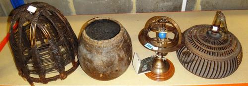 An Oriental cane bird cage, an animal hide pot, a cane pot and a brass skeletal astrolabe.