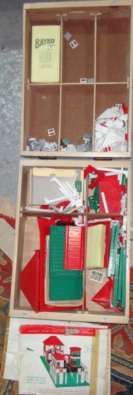 A quantity of Bayko toy building blocks in a wooden box.