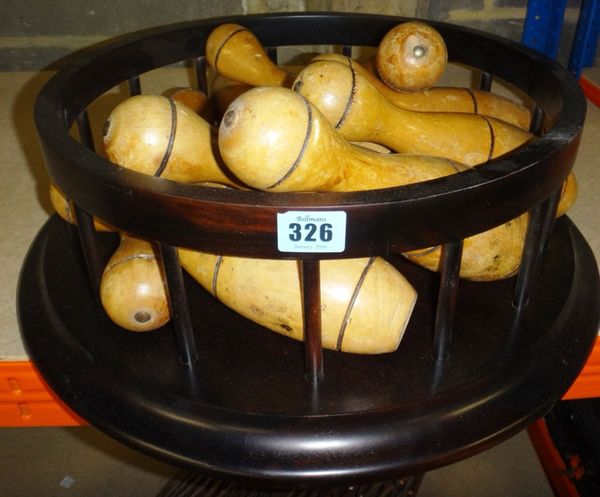 A quantity of wooden skittles, a circular ebonised stand, and two hazel wood metamorphic spheres.