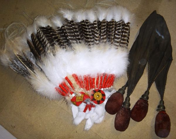 A Native American head dress, together with a decorative tribal hanging.