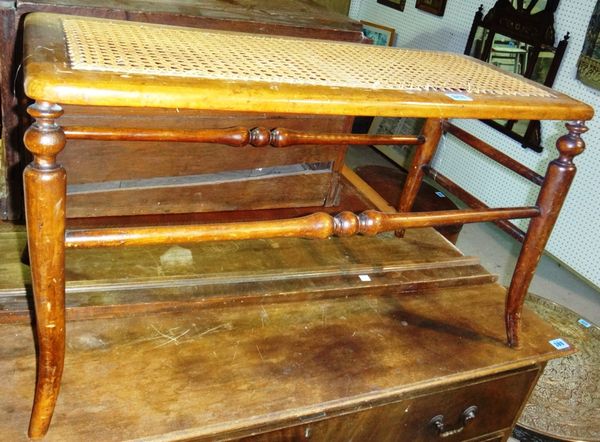 A 19th century walnut and cane long stool.