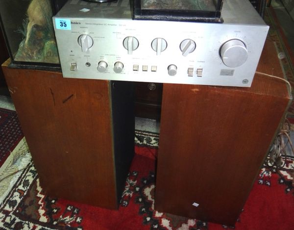 A 20th century Technics amplifier and a pair of B & O speakers.