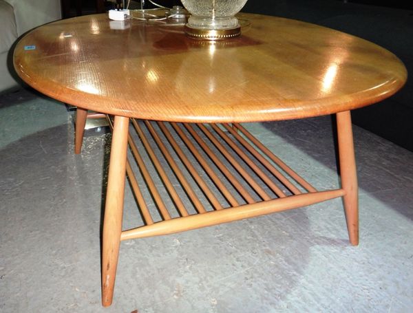 A 20th century elm Ercol oval coffee table, designed by Lucien Ercolini