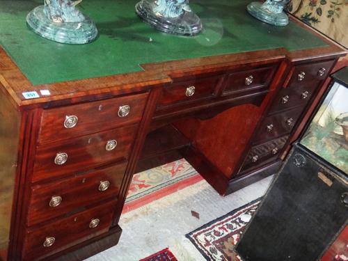 A 19th century mahogany breakfront writing desk with green leather top and a mahogany chair.