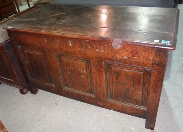 An 18th century oak coffer with panel decoration.