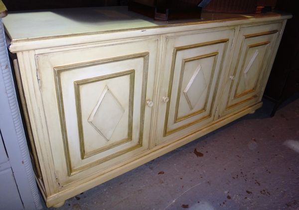 A cream painted rectangular sideboard.