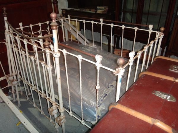A Victorian wrought iron white painted cot.