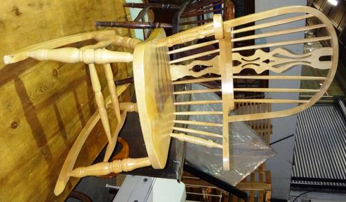 A 20th century beech stick back rocking chair, together with a 20th century mahogany tripod table.