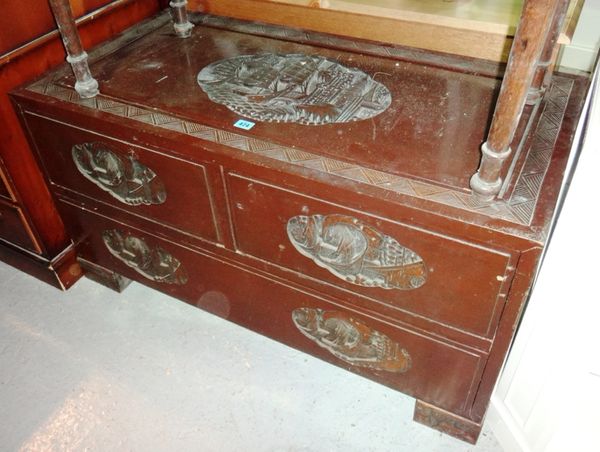 A 20th century low carved hardwood chest.
