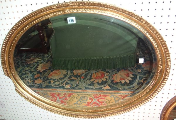 An oval gilt framed wall mirror.