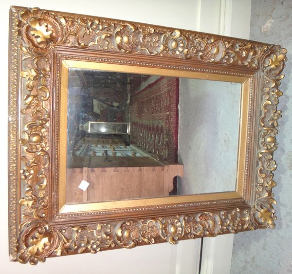 A 20th century heavily moulded gilt framed wall mirror, together with a copper circular mirror (2).