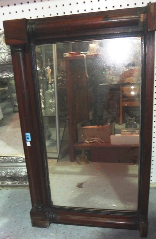 A mahogany overmantel mirror and a shield shaped mirror.