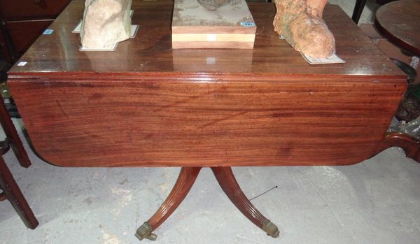 A 19th century drop flap mahogany pedestal dining table.