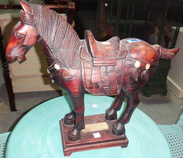 A 20th century Oriental hardwood figure of a horse.