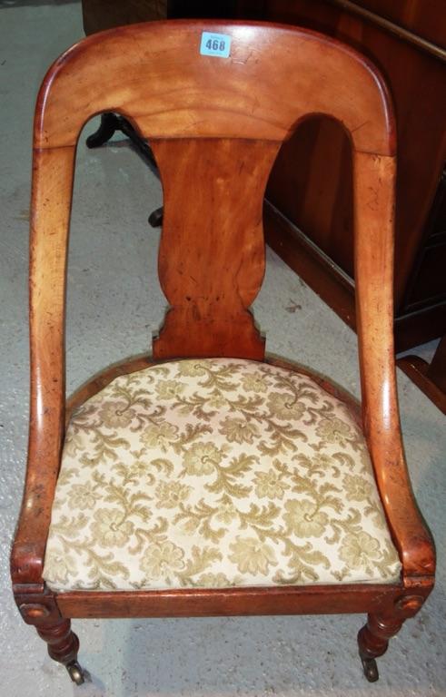 A 19th century walnut child's tub back chair.