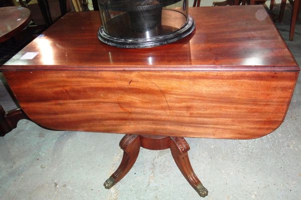 A 19th century mahogany drop flap Pembroke table with turned column and four outswept supports.
