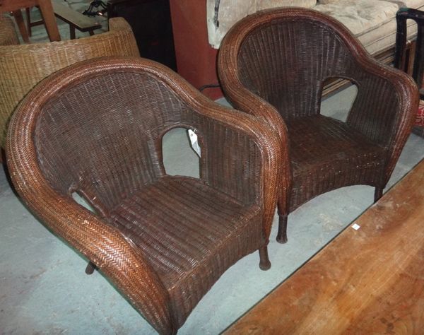 A pair of brown stained rattan tub armchairs.