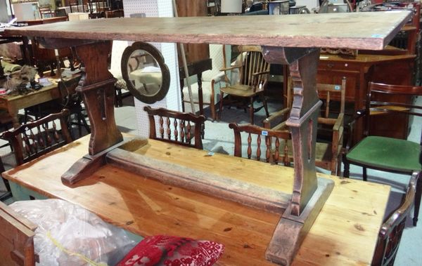 A 19th century oak rectangular dining table on trestle style supports.
