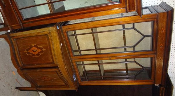 A 19th century mahogany inlaid serpentine bookcase cabinet.