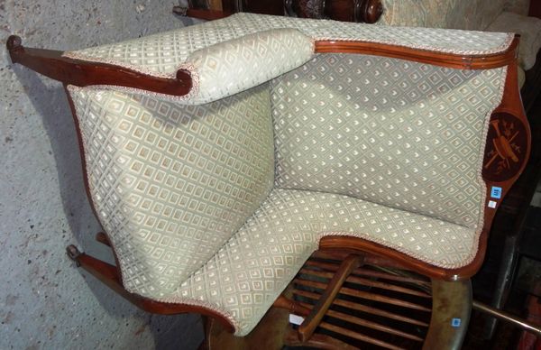 An Edwardian mahogany framed upholstered wing armchair.