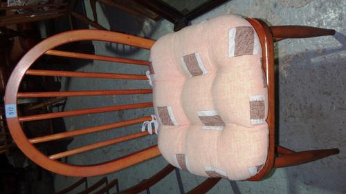 A set of four Ercol stick back dining chairs.