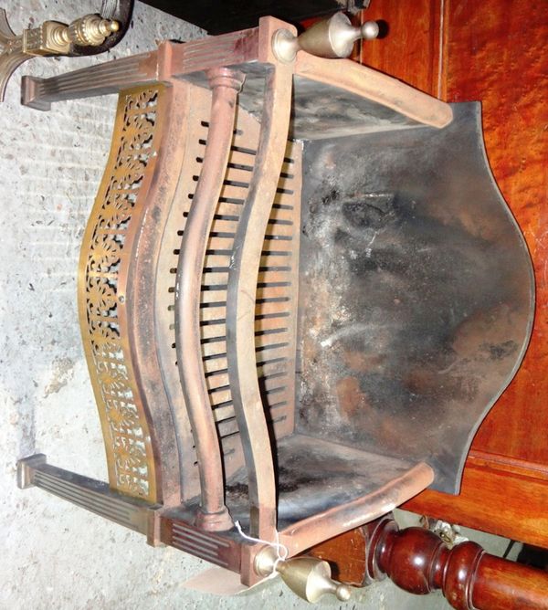 An iron and steel fire grate with an integral back.