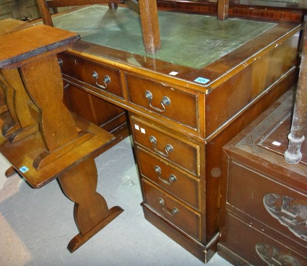 A 20th century yew wood pedestal desk with inset green leather top.