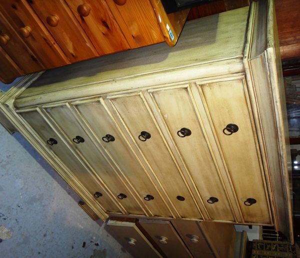 A 20th century cream painted tall chest of six long drawers.