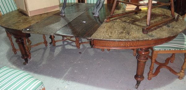A 19th century oak extending dining table on turned supports, to include two extra leaves.