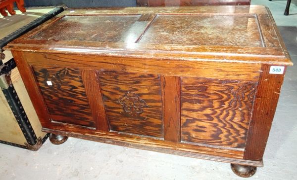 A 20th century oak coffer with panelled decoration.