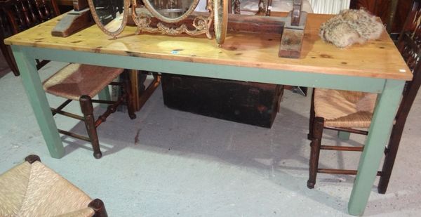A rectangular pine dining table with green painted base.
