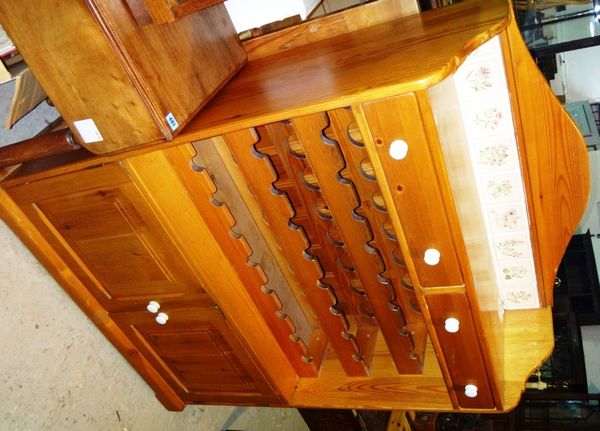 A 20th century pine side cabinet with a fitted wine rack interior.