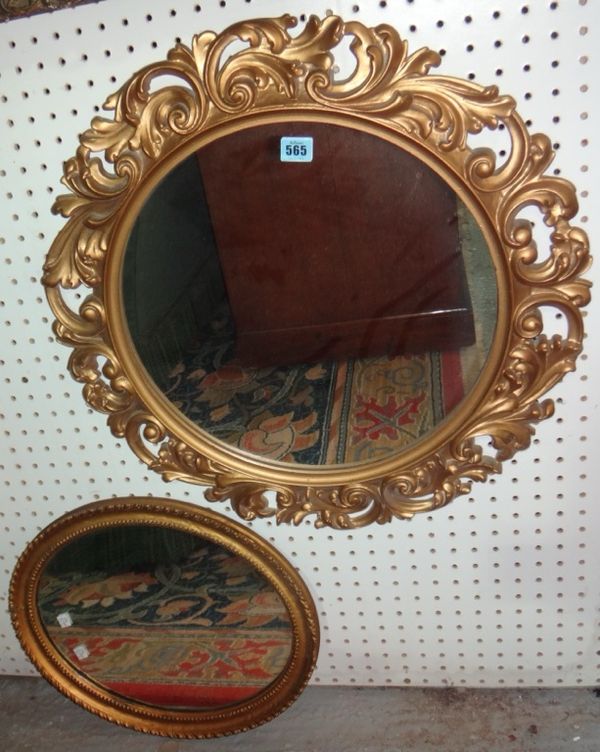 A group of four gilt framed wall mirrors.