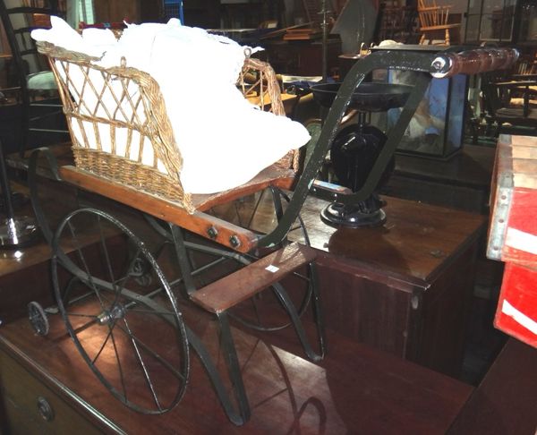 A 20th century reproduction of an early 19th century doll's pram.