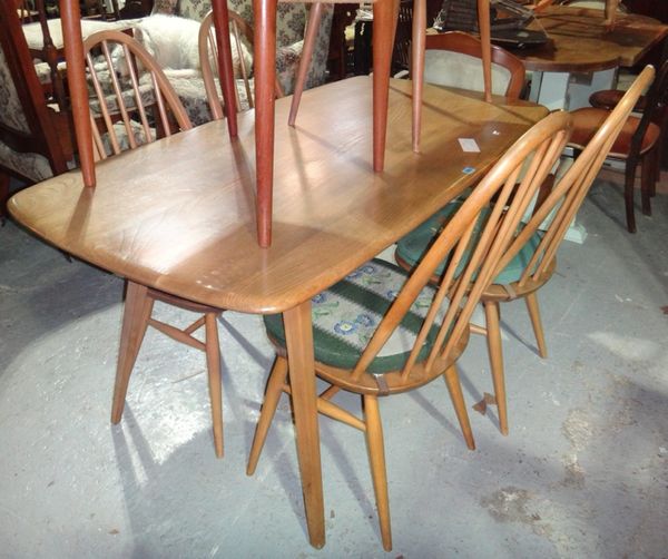 An Ercol dining table and a set of four chairs.