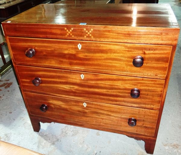 An early 19th century mahogany chest with inlaid frieze.
