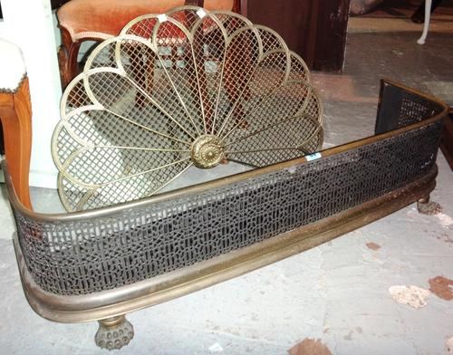 A 19th century pierced brass fender and a wirework spark guard.