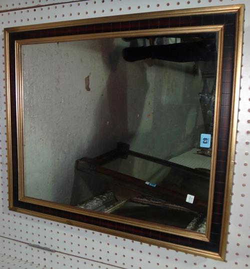 A 20th century rectangular gilt and ebonised wall mirror.