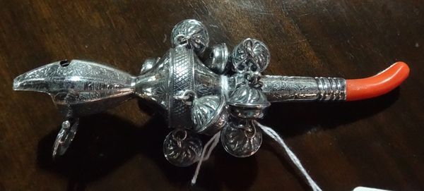 A Continental white metal child's rattle, detailed 800, with whistle pendant bells and 'coral' teether.