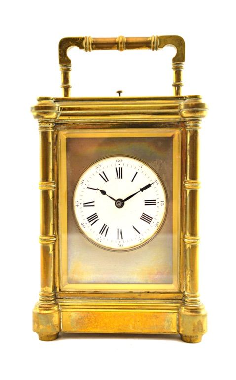 A brass cased carriage clock, late 19th century, with push hour repeat and two train movement and a white enamel dial, in a pillar cast case, 15cm hig