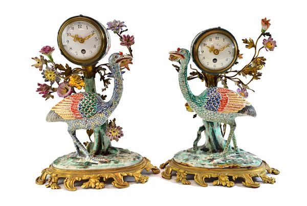 A pair of Chantilly style porcelain and ormolu mantel clocks, late 19th/early 20th century, each modelled with a wild bird to the foreground with a fl